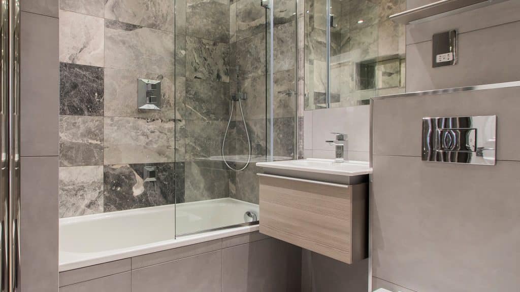 Gloucester Terrace Luxury bathroom with marble tiles, glass shower, and floating vanity