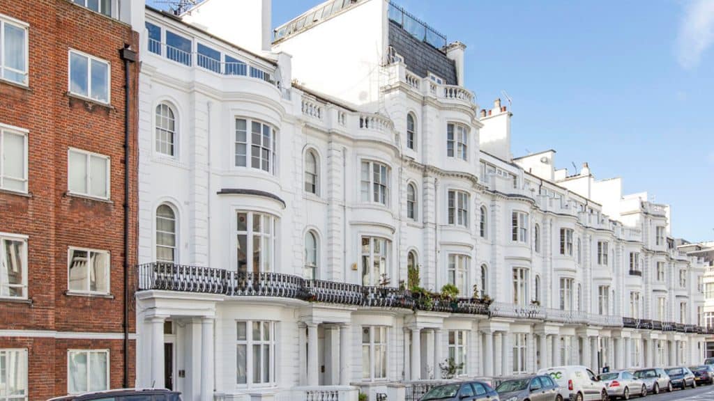 Exterior view of a classic white London townhouse with detailed architecture