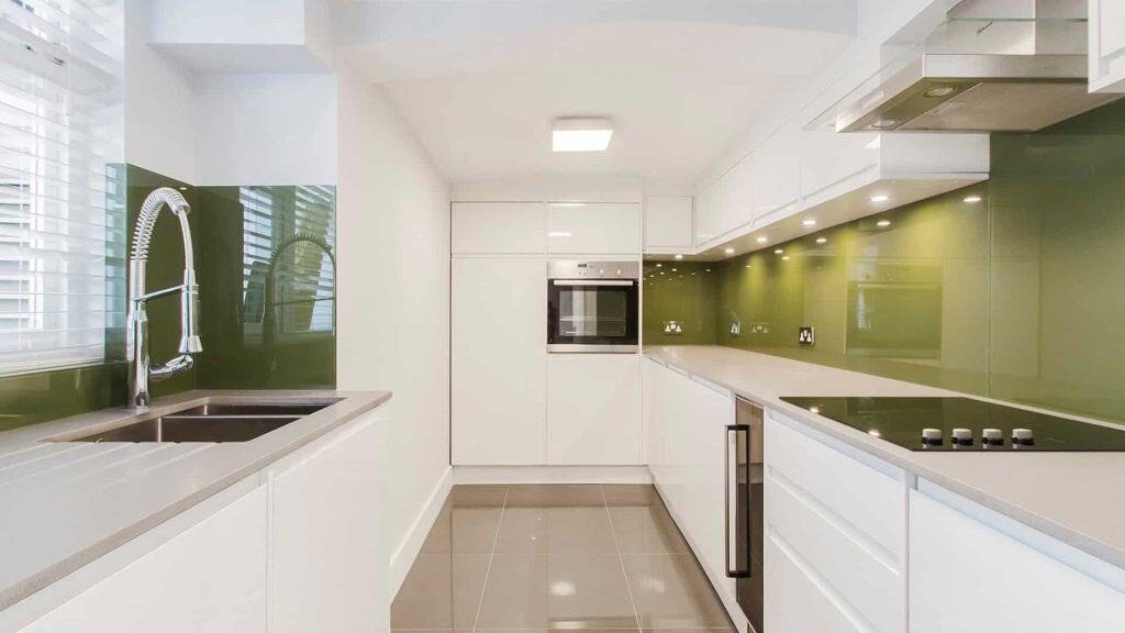 Minimalist kitchen with white cabinetry and sleek modern appliances
