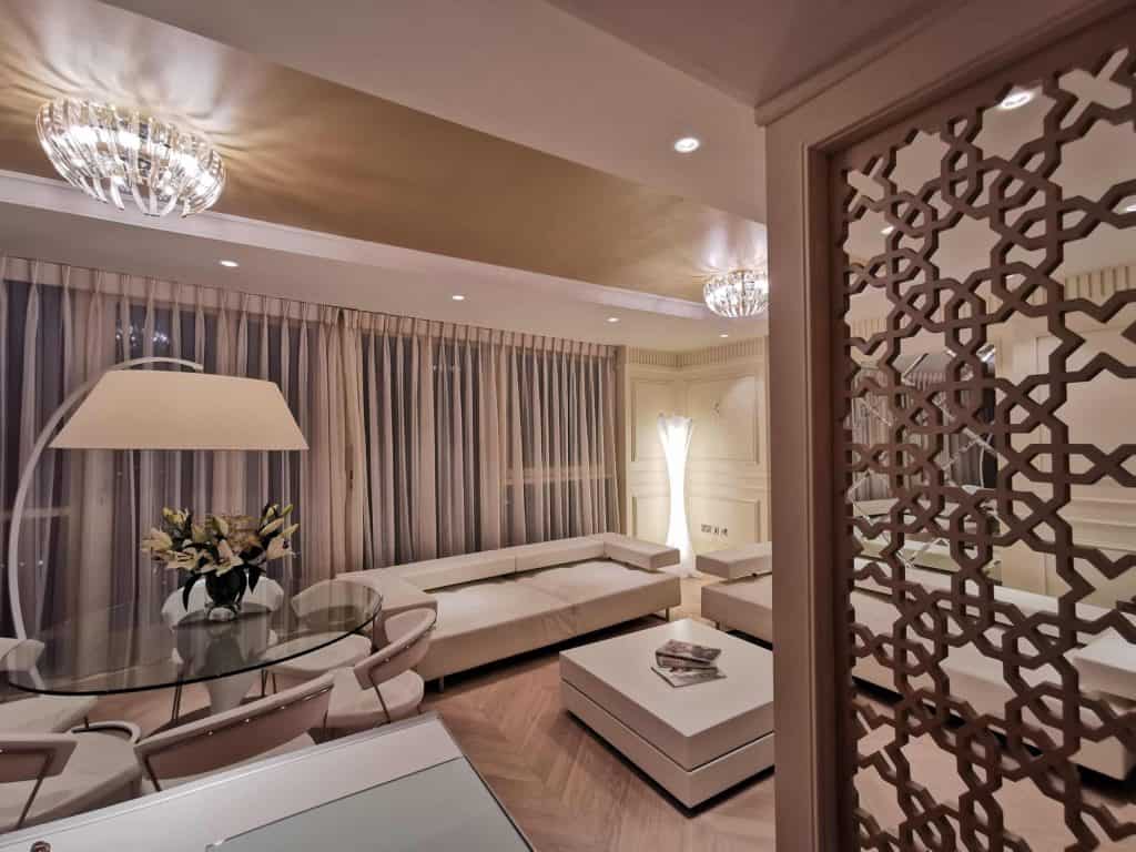 Paddington Sophisticated living room with sectional sofa, glass table, and elegant decor