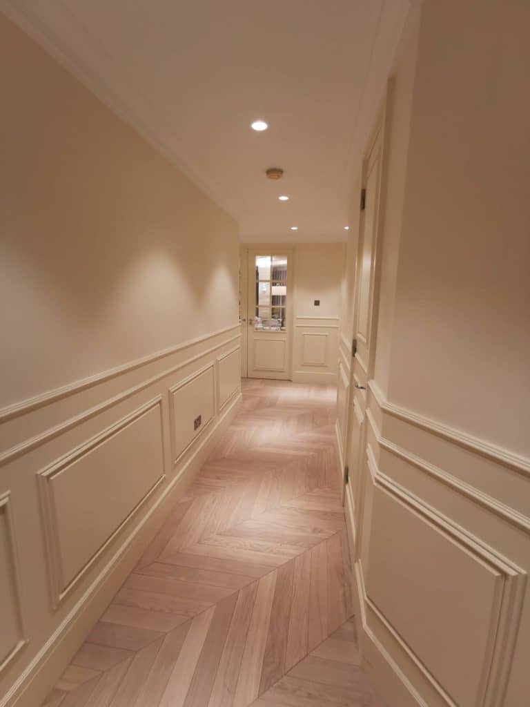 Paddington Elegant hallway with soft lighting and classic wall paneling
