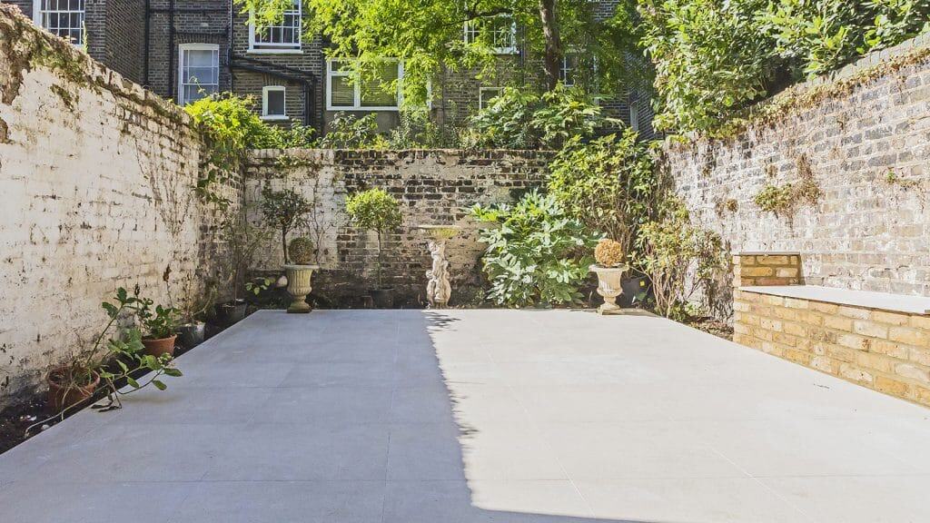 Pimlico Private outdoor patio with greenery and a bright concrete floor