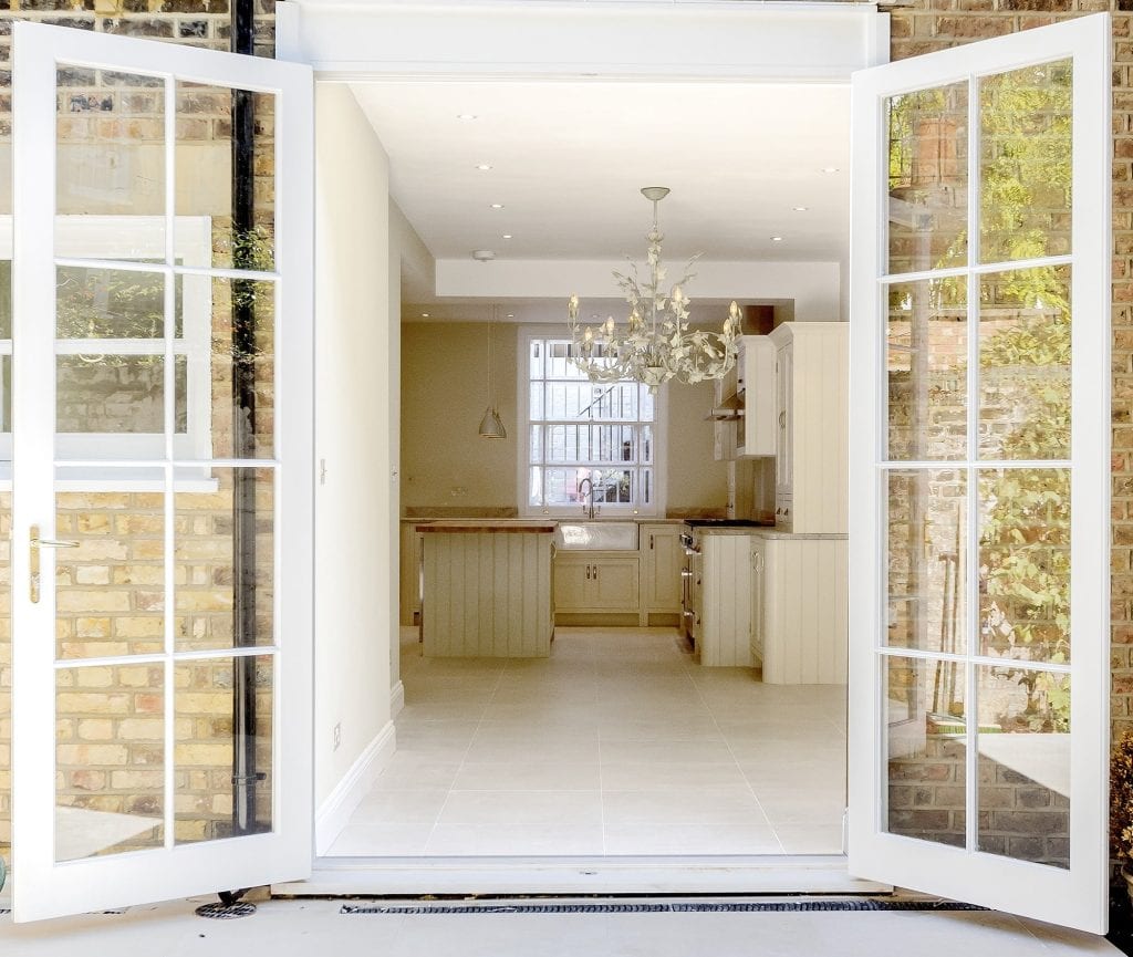 Pimlico Open-plan kitchen with white cabinetry and large French doors