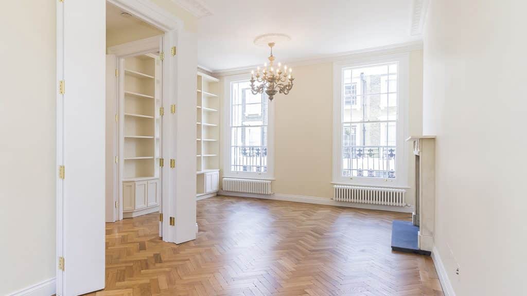 Pimlico Spacious living room with hardwood floors, built-in shelves, and a chandelier